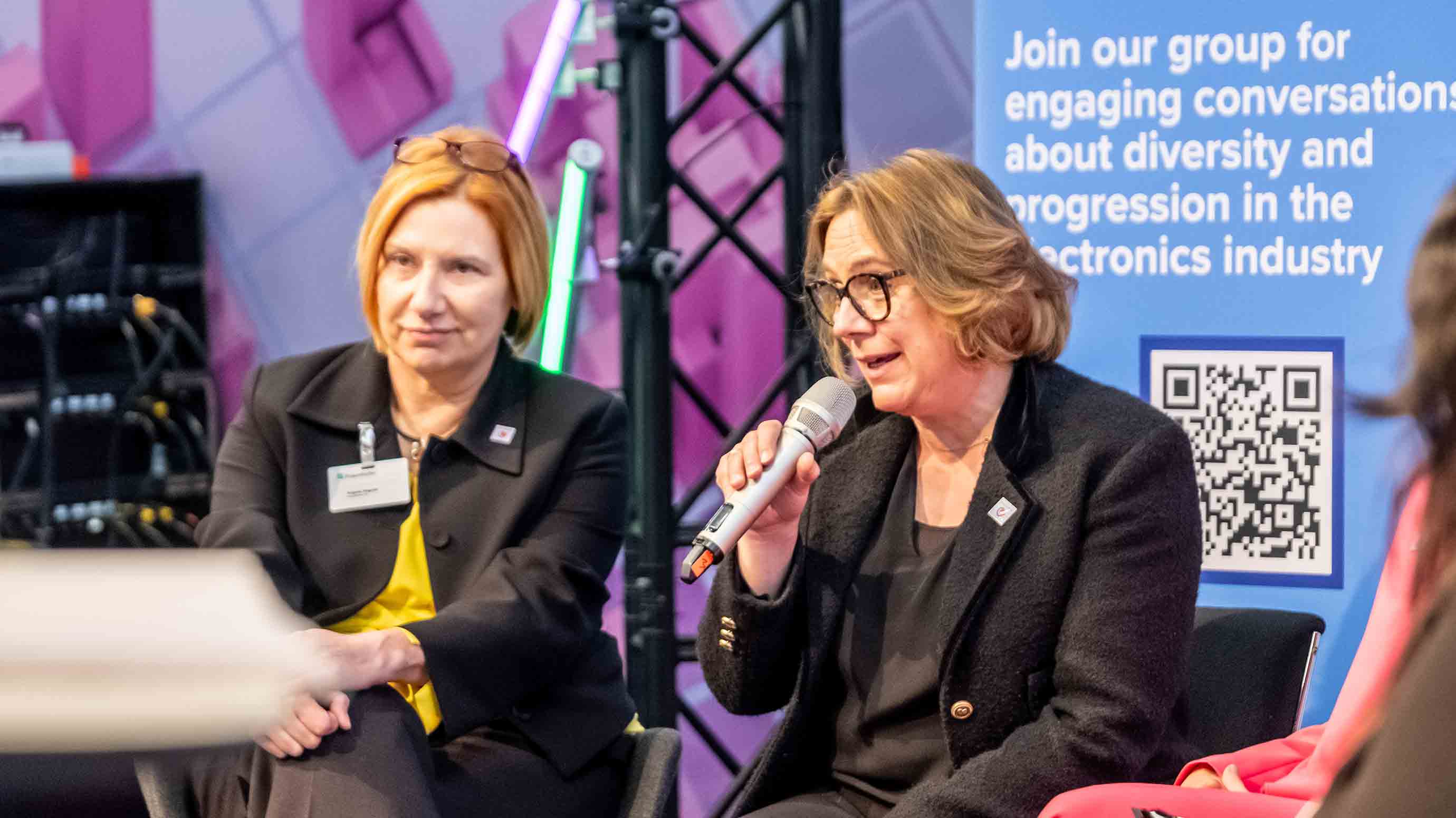 Two speakers on stage at women4ew